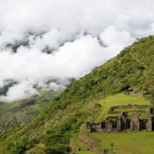 The ruins of Choquequirao surrounded by lush greenery.