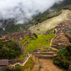 A view of Machu Picchu on a cloudy day from the nearby peak of Huchuy Picchu.