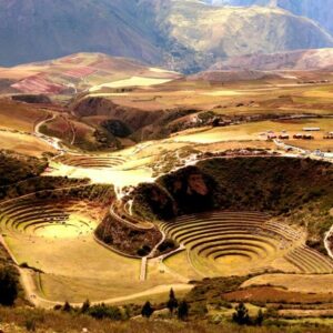 Panoramic view of Moray’s circular agricultural terraces in the Sacred Valley, surrounded by Andean mountains and open sky.